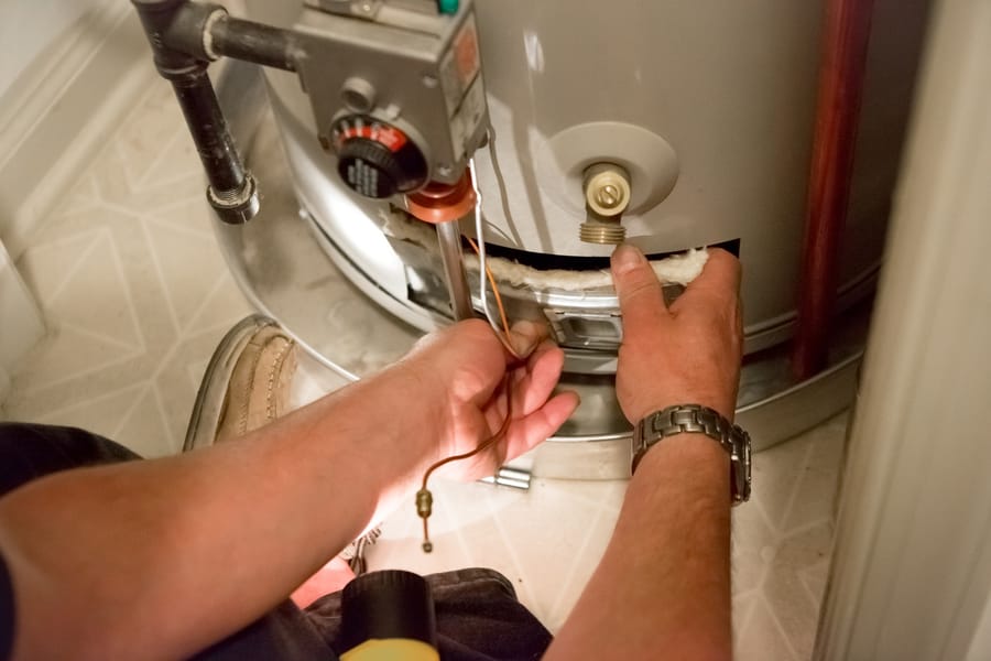 A plumber performing maintenance on water heater