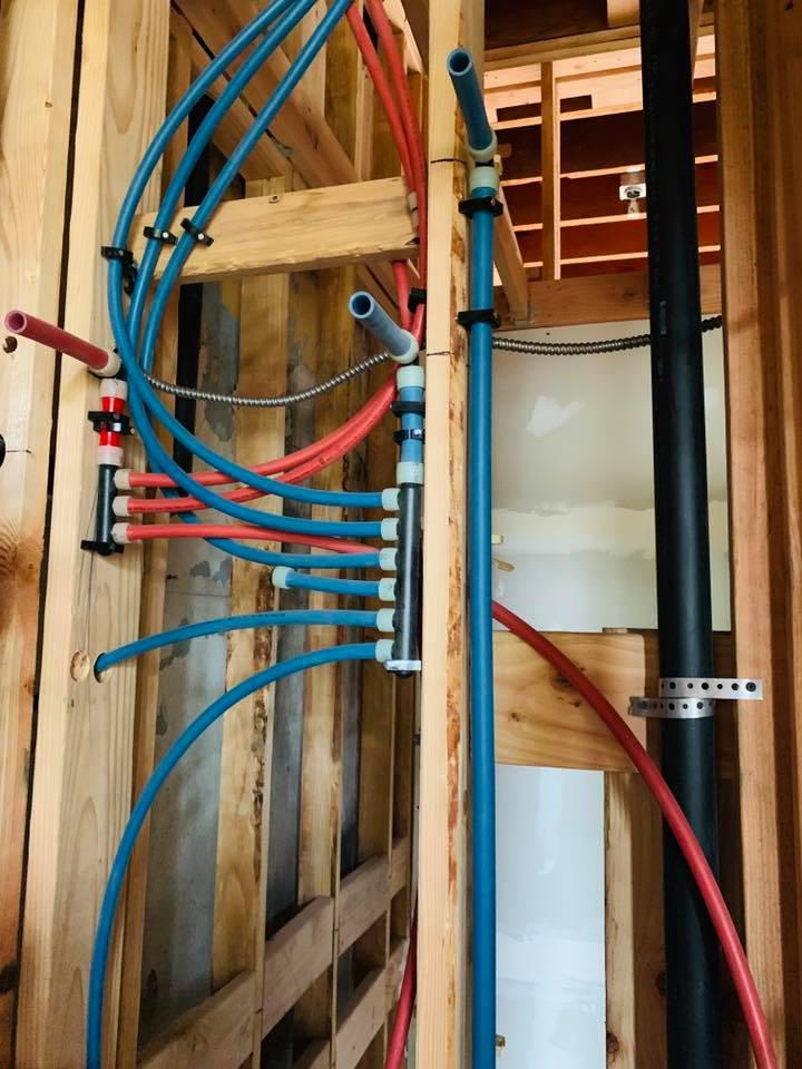 red and blue PEX pipes installed in home