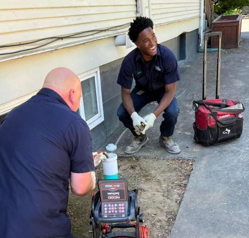 Olympic Plumbing Technology technicians performing a drain cleaning service at a home in the South Sound area