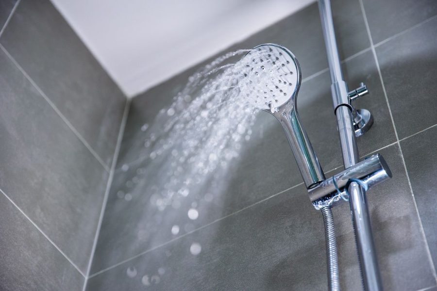 Stainless steel showerhead with water flowing out of it